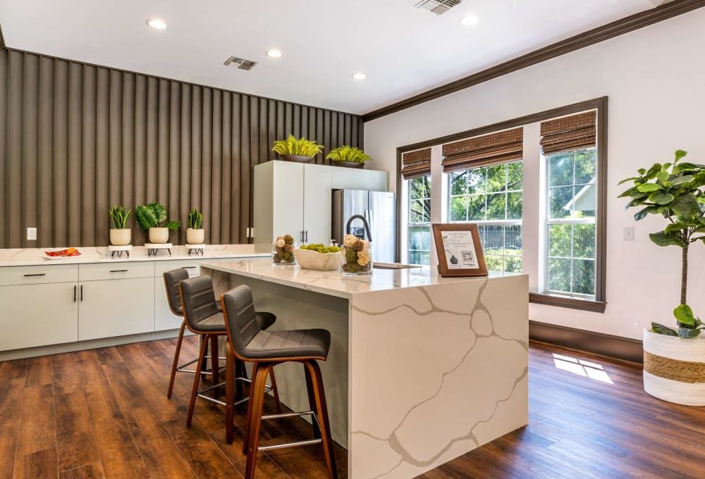 a kitchen with wood floors and a large island at The  Pines on Spring Rain