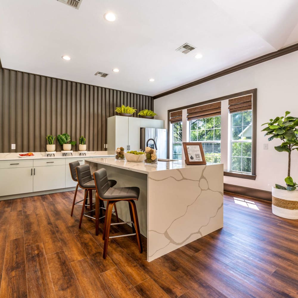 a kitchen with wood floors and a large island at The  Pines on Spring Rain