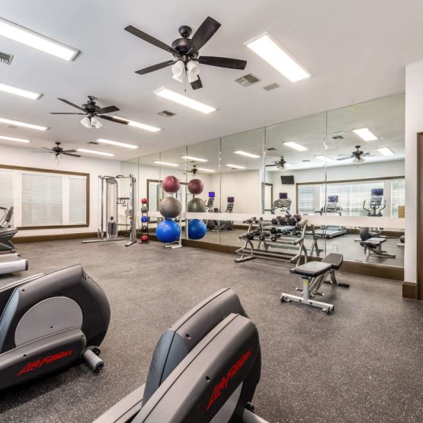 a gym room with exercise equipment and ceiling fans at The  Pines on Spring Rain