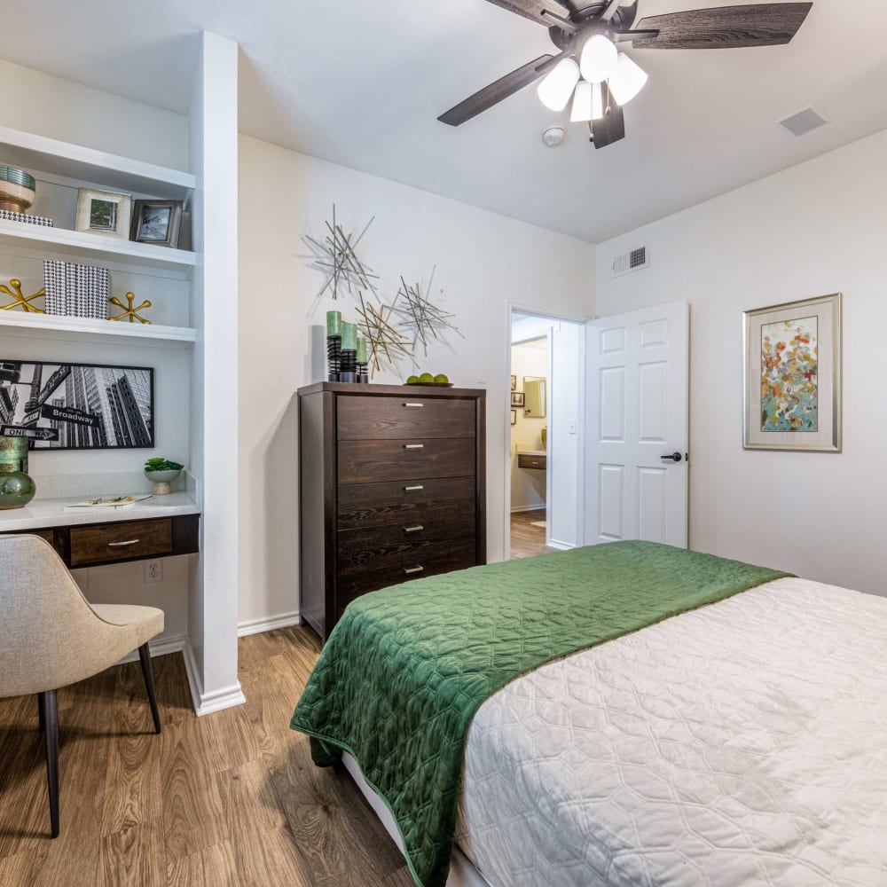 a bedroom with a green bed and white dresser at The  Pines on Spring Rain